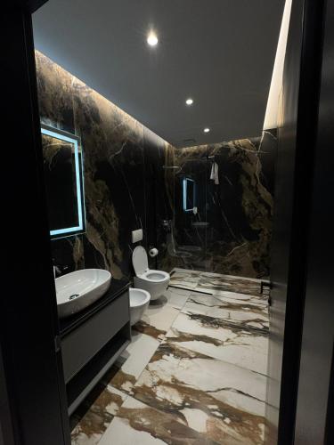 a bathroom with a sink and a toilet at Hotel Lezha Park in Ishull-Lezhë