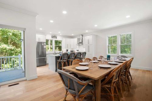 a kitchen and dining room with a table and chairs at Sprawling Home 1 Mi to Downtown in Harwich