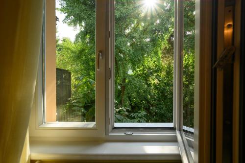 a window with a view of a tree at Landhaus Hindenburg in Bad Gleichenberg
