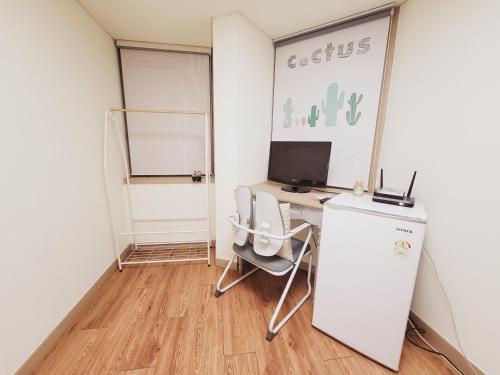 a small office with a desk with a computer on it at BK Room in Incheon