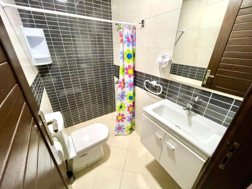 a small bathroom with a toilet and a sink at Marchica bay 20 holiday apartment in Nador