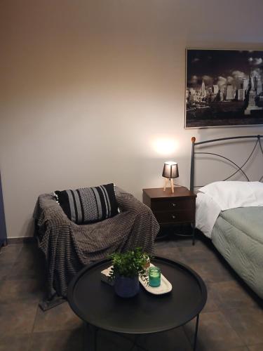 a living room with a bed and a coffee table at My Home 3 in Amaliás