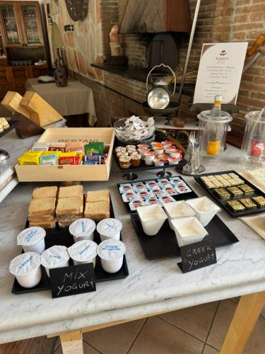 a table topped with different types of pastries and desserts at Avernum Relais Hotel e Ristorante in Pozzuoli