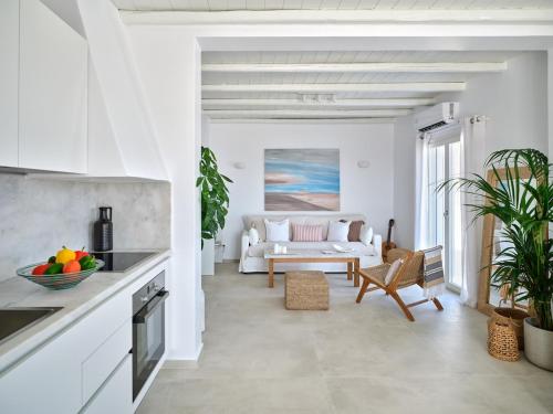 a white living room with a couch and a table at Parian Pearl Unique SeaView in Naousa