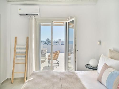 a bedroom with a bed and a view of the ocean at Parian Pearl Unique SeaView in Naousa