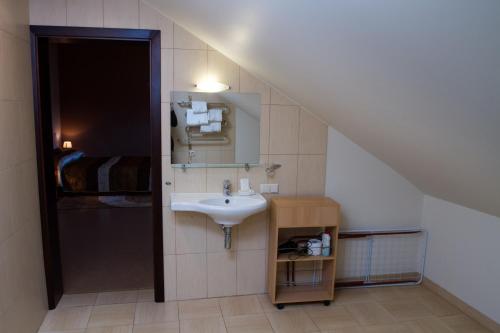 a bathroom with a sink and a staircase at Po Jūros Banga in Palanga