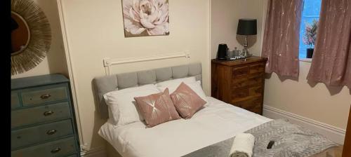 a bedroom with a white bed with two pillows at 106 Brynmill - Room 2 in Sketty
