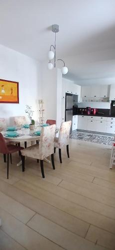 a dining room with a table and chairs and a kitchen at Σπίτι - Κάστρο πάνω από τη θάλασσα in Piraeus