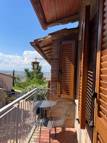a patio with a table and a chair on a balcony at Boutique Hotel Masolino in Panicale