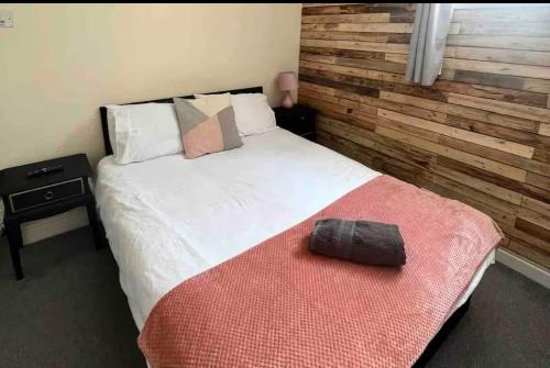 a bedroom with a large bed with a red blanket at 106 Brynmill - Room 3 in Sketty