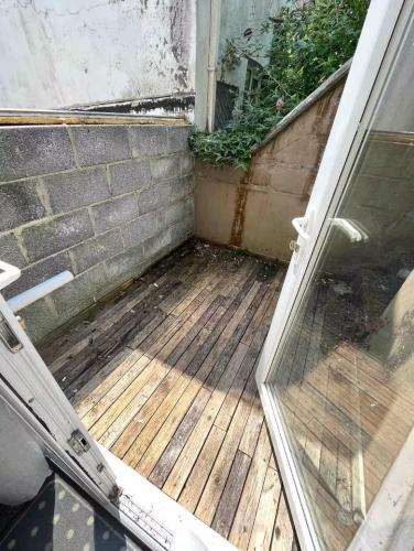 an open door to a porch with a wooden deck at 106 Brynmill - Room 3 in Sketty