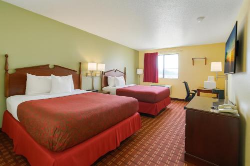 a hotel room with two beds and a television at Days Inn by Wyndham Morton in Morton