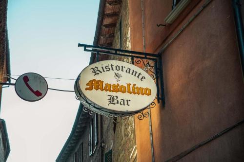 a sign for a restaurant on the side of a building at Boutique Hotel Masolino in Panicale