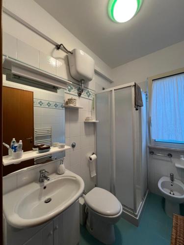 a bathroom with a sink and a toilet and a shower at La Casa al Mare in Scalo dei Saraceni Manfredonia