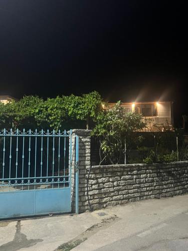a gate in front of a house at night at Leone Guesthouses in Borsh