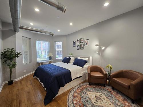 a bedroom with a bed and a chair and a rug at Luxe Loft vibe with King Suite - 4BR 3Ba in Chicago