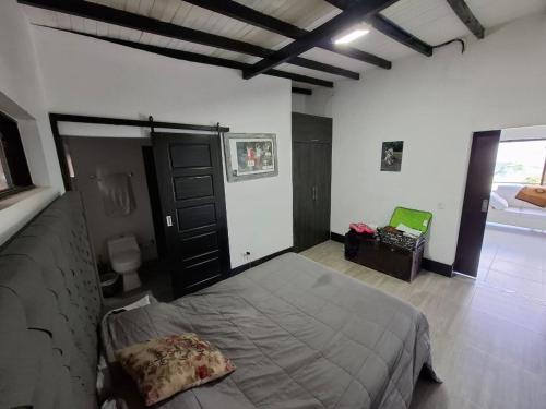 a bedroom with a large bed in a room at Casa de lujo wifi jacuzzi charcos parking in Barbosa