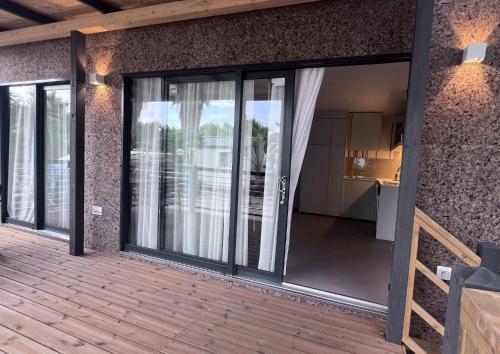 an open sliding glass door on a patio with a kitchen at Villaggio Dei Fiori in Sanremo
