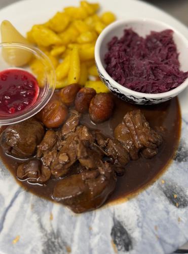 a plate of food with mushrooms and french fries at Hotel Restaurant Edelweiss in Mühlen