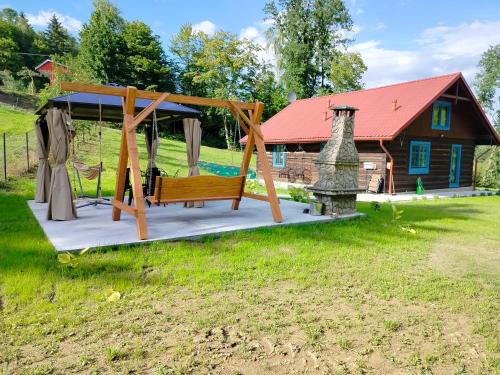 a swing set in front of a house at Chata pod lasem 