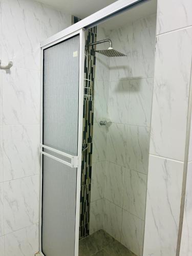 a shower with a glass door in a bathroom at Mar de Indias House in Cartagena de Indias