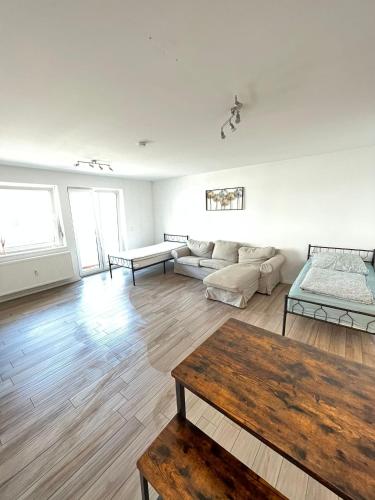 a living room with a couch and a table at Monteurwohnung Pforzheim mit Balkon - QuartierPro in Pforzheim