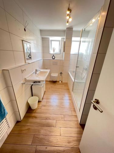 a bathroom with a sink and a shower and a toilet at Monteurwohnung Pforzheim mit Balkon - QuartierPro in Pforzheim