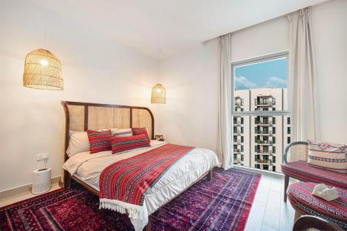 a bedroom with a bed and a large window at 1BR Yas Marina Apartment - Near Ferrari World in Abu Dhabi