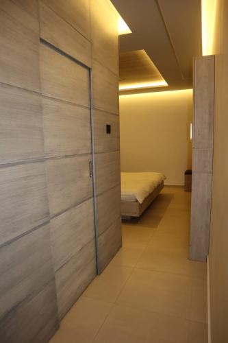 a bedroom with a sliding door with a bed at Casa El Haje in Al Maşyaf