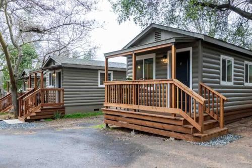 a log cabin with a porch and a deck at Columbia Cabins Cabin 4 in Sonora