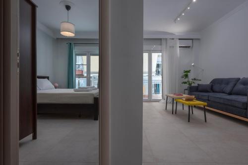 a living room with a couch and a bed at Angel's Urban Up-ART-ment in Thessaloniki