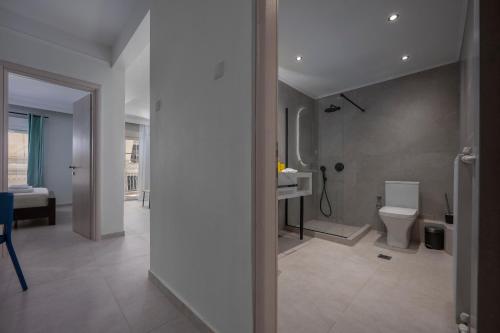 a bathroom with a toilet and a sink in it at Angel's Urban Up-ART-ment in Thessaloniki