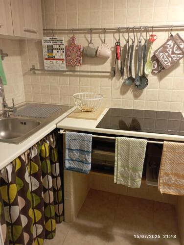 a kitchen with a sink and a counter with towels at Casa Vacanze GANGEL in Casalabate