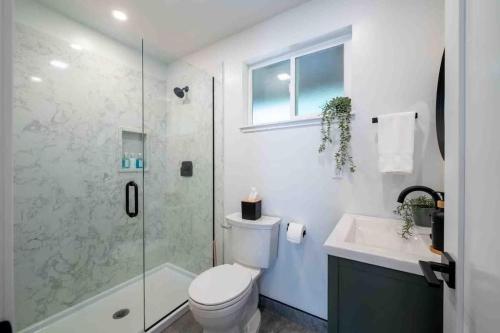 a bathroom with a toilet and a shower and a sink at Columbia Cabins Cabin 6 in Sonora