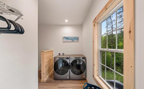a washer and dryer in a laundry room with a window at Luxe Retreat - King Beds - Sept Dates! - Easy drive - XL Swim Spa - Award Winning! in Sevierville