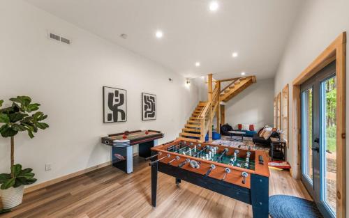 a room with a ping pong table and a staircase at Luxe Retreat - King Beds - Sept Dates! - Easy drive - XL Swim Spa - Award Winning! in Sevierville