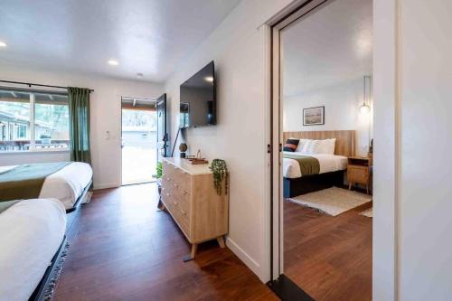 a bedroom with two beds and a mirror at Columbia Cabins Cabin 7 in Sonora