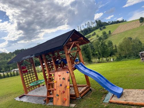 a play structure with a slide and a slideintendangering at Bieszczadzki domek in Wola Matiaszowa