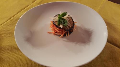 a white plate with food on a table at Agriturismo Duca di San Martino in Partanna