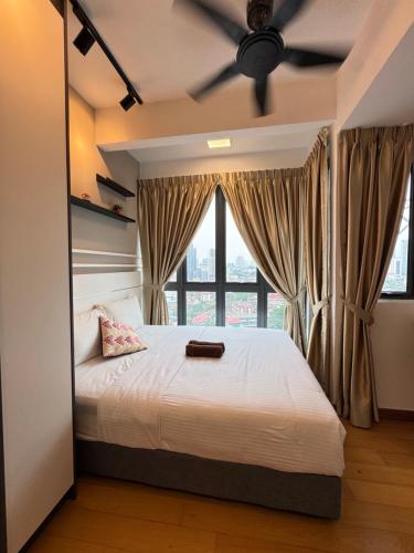 a bedroom with a bed with a ceiling fan at Luxe by KLCC in Gua Sai