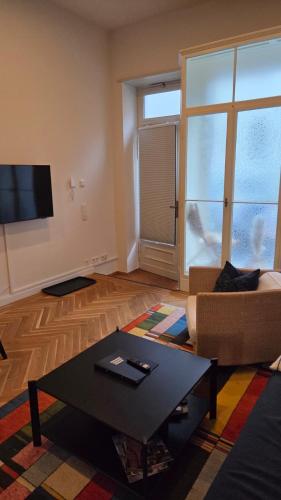 a living room with a couch and a coffee table at EG-Apartment mit Terrasse in Görlitzer Innenstadtlage! in Görlitz
