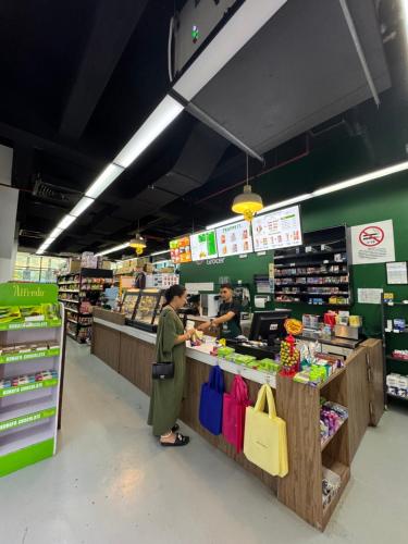 two people standing at a counter in a supermarket at Luxe by KLCC in Gua Sai