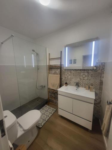 a bathroom with a white toilet and a sink at Spring Water House in Olho Marinho