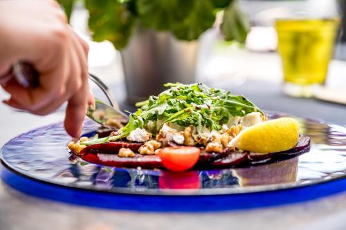 a person eating a plate of food on a table at Ruhpoldinger Hof - Hotel & Wellness in Ruhpolding