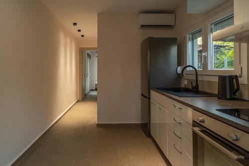 a kitchen with a sink and a counter at Elonea Villas, Luxury Villas and Studios in Kallikrateia Halkidiki with Garden, Veranda & BBQ in Nea Kalikratia