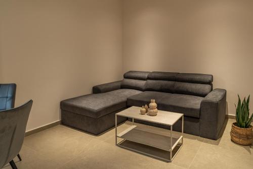 a living room with a couch and a coffee table at Elonea Villas, Luxury Villas and Studios in Kallikrateia Halkidiki with Garden, Veranda & BBQ in Nea Kalikratia