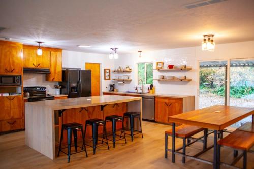 a kitchen with a large island with bar stools at Modern Gorge Lodge in The Dalles