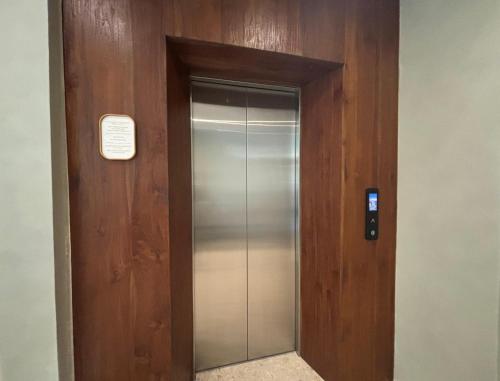 an elevator in a building with a sign on it at Hygge Hotel and Villas Seminyak in Seminyak