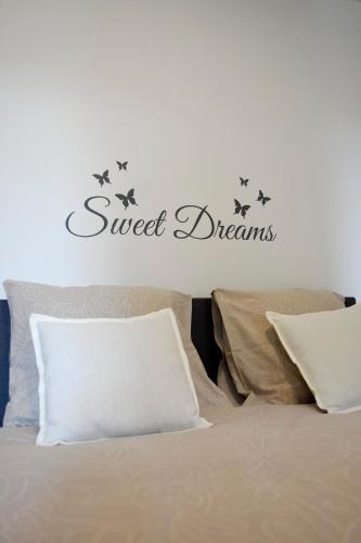 a bedroom with a bed with a sign that reads sweet dreams at Bartine - modern and spacious flat near the sea, free parking space in Ostend