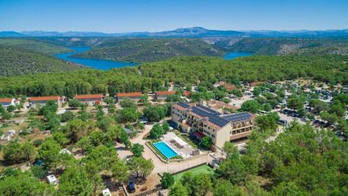 an aerial view of a resort with a pool at Hotel Vrata Krke in Lozovac